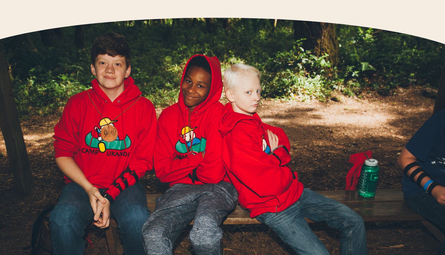 Three boys in camp sweatshirts